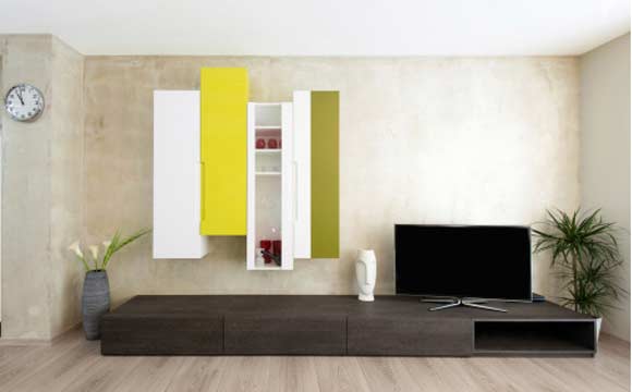 A TV em cima do rack, com a parede em outra cor é outra opção muito utilizada. Em uma sala grande, podem-se usar cores escuras